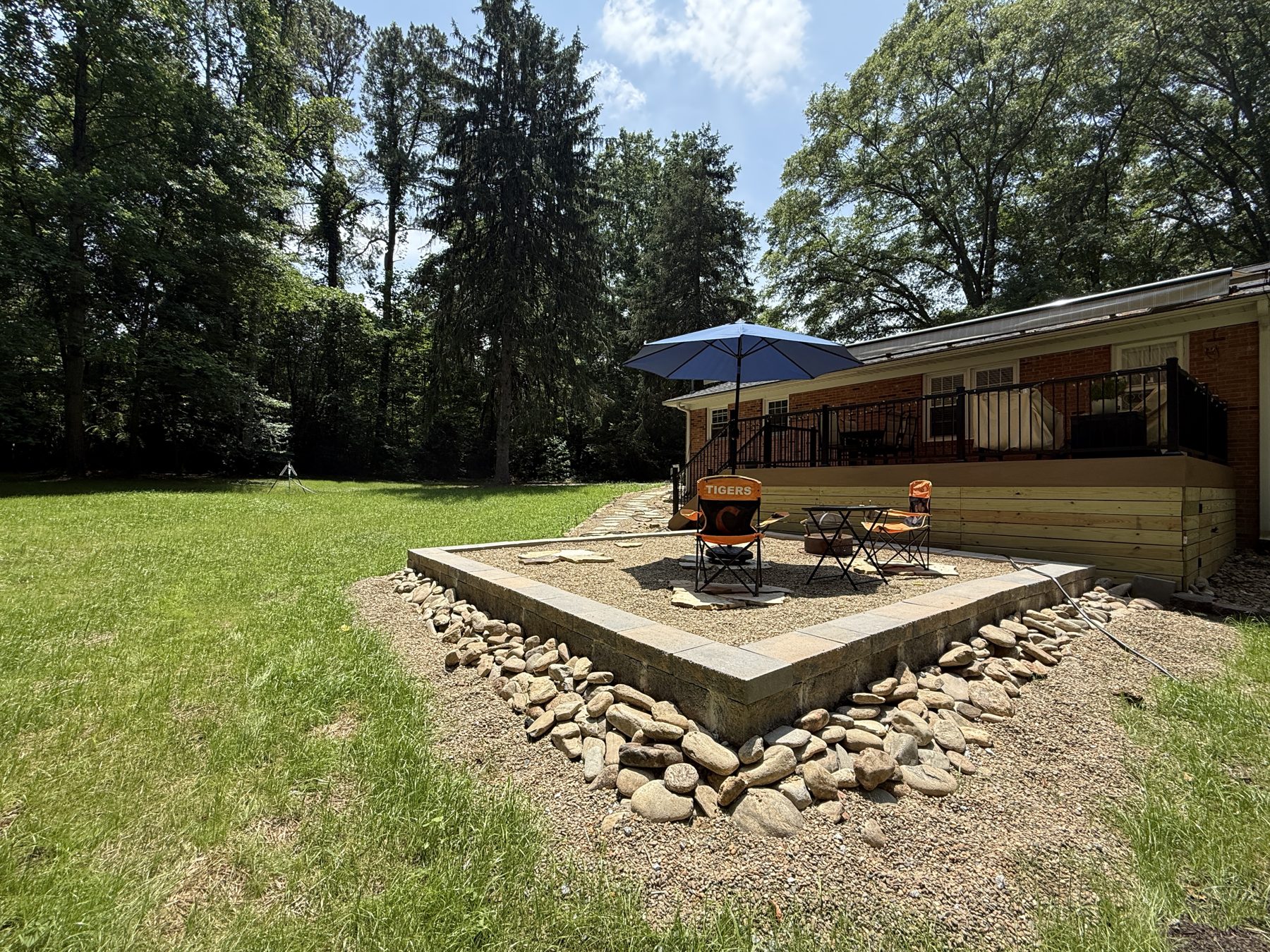 Gravel patio with paver border and fire pit area — hardscaping Upstate SC