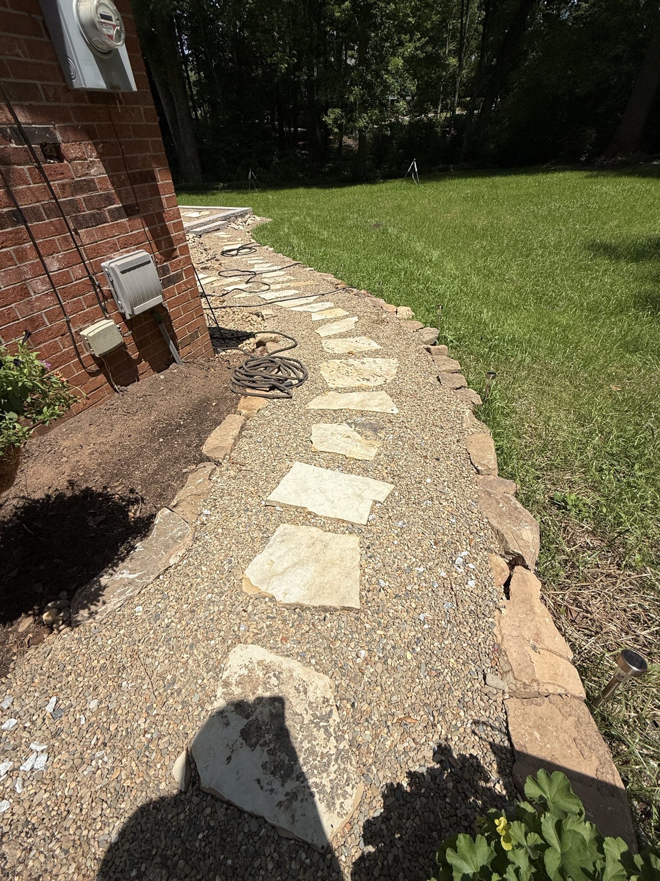 Flagstone and gravel walkway with stone border — hardscaping Greenville SC